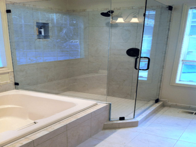 Glass enclosed shower with granite walls