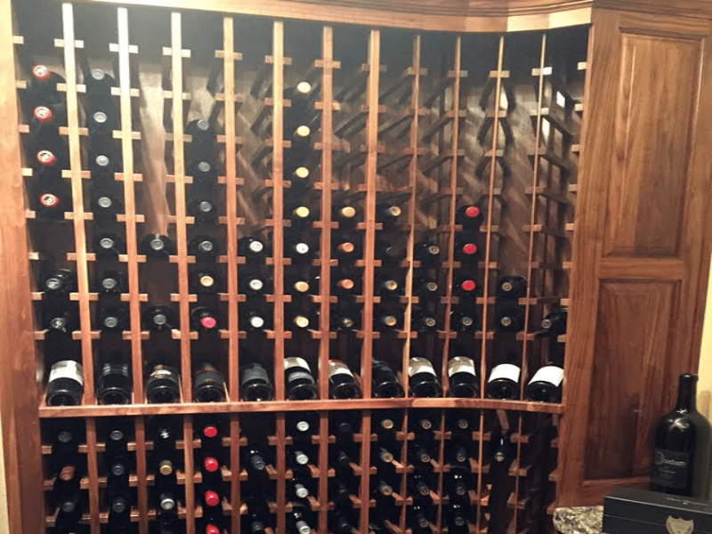 Custom wine storage rack made with walnut wood in new wine cellar.