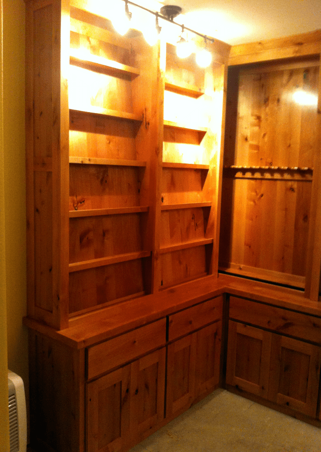  Custom wooden shelving with gun racks 